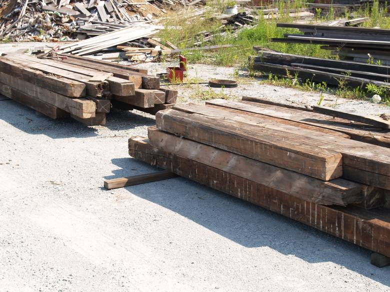 Dual timber piles. / Shot from distance, two piles.